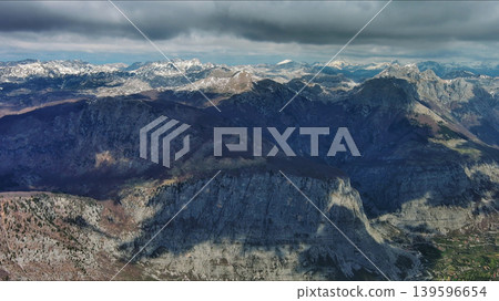 Aerial view of rocky mountain peak and green valley 139596654