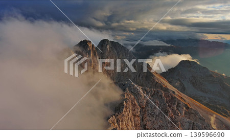 Amazing rocky mountains in clouds at sunset 139596690