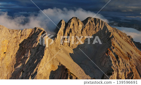 Amazing rocky mountains in clouds at sunset 139596691