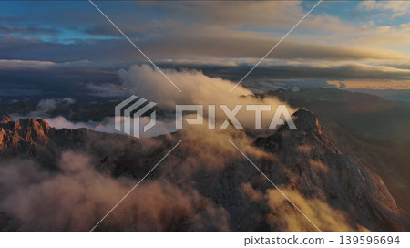 Amazing rocky mountains in clouds at sunset 139596694