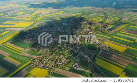 Agricultural fields with yellow rapeseed and village Agricultural fields with yellow rapeseed and village 139596701