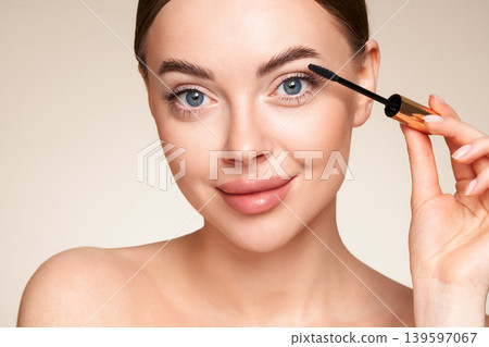 Beauty woman applying black mascara on eyelashes Beauty woman applying black mascara on eyelashes 139597067