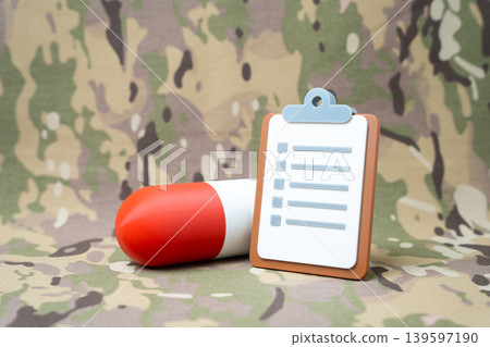 A tablet and medication against a military background. Medical examination for military personnel. Health criteria for enlistment. Specialized medications and military healthcare support systems. A tablet and medication against a military background. Medical examination for military personnel. Health criteria for enlistment. Specialized medications and military healthcare support systems. 139597190