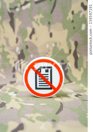 A paper document ban symbol against a military background. Digitalization and automation of bureaucratic processes, reports, and statements. Transition to secure electronic military records. A paper document ban symbol against a military background. Digitalization and automation of bureaucratic processes, reports, and statements. Transition to secure electronic military records. 139597191
