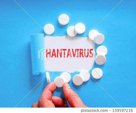 Hantavirus medical words symbol. Concept words Hantavirus on beautiful white paper. Beautiful blue background. Doctor hand. Beautiful white pills. Medical Hantavirus concept. Copy space. 139597216