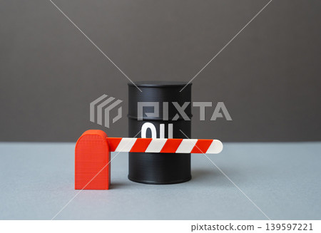 A barrel of oil behind a barrier. Blockade and restrictions on the supply and transportation of oil. Embargo, sanctions pressure and disruption of global trade routes. 139597221