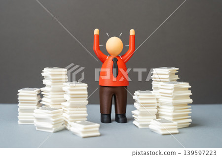 An office worker reacting sharply to a backlog of work. Bureaucratic overload. Overwhelmed at work, stress management and corporate productivity problems. An office worker reacting sharply to a backlog of work. Bureaucratic overload. Overwhelmed at work, stress management and corporate productivity problems. 139597223