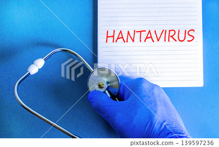 Hantavirus medical words symbol. Concept words Hantavirus on beautiful white note. Beautiful blue background. Doctor hand with pen. Blue glove. Stethoscope. Medical Hantavirus concept. Copy space. Hantavirus medical words symbol. Concept words Hantavirus on beautiful white note. Beautiful blue background. Doctor hand with pen. Blue glove. Stethoscope. Medical Hantavirus concept. Copy space. 139597236