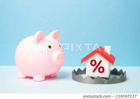 The piggy bank and the mortgage trap. The threat of losing all savings by taking out an unfavorable home loan. Debt burden, banking pressure and housing risks. The piggy bank and the mortgage trap. The threat of losing all savings by taking out an unfavorable home loan. Debt burden, banking pressure and housing risks. 139597237