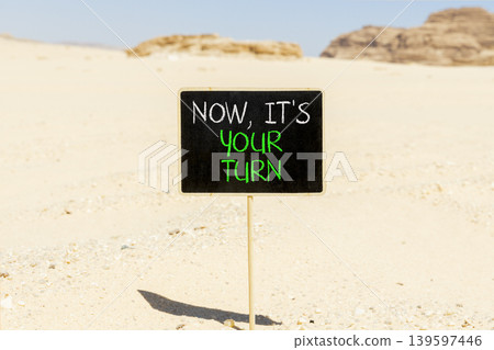 Now it's your turn symbol. Concept words Now it's your turn on beautiful blackboard. Beautiful Sinai desert sand background. Business Now it's your turn motivational support concept. Copy space. Now it's your turn symbol. Concept words Now it's your turn on beautiful blackboard. Beautiful Sinai desert sand background. Business Now it's your turn motivational support concept. Copy space. 139597446