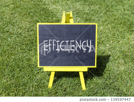 Efficiency symbol. Concept word Efficiency on beautiful black blackboard. Beautiful green grass lawn background. Business efficiency concept. Copy space. Efficiency symbol. Concept word Efficiency on beautiful black blackboard. Beautiful green grass lawn background. Business efficiency concept. Copy space. 139597447