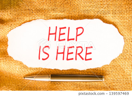 Help is here and support words symbol. Concept words Help is here on beautiful white paper. Beautiful canvas background. Business help is here and support concept. Copy space. Help is here and support words symbol. Concept words Help is here on beautiful white paper. Beautiful canvas background. Business help is here and support concept. Copy space. 139597469