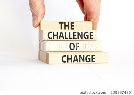 The challenge of change symbol. Concept words The challenge of change on beautiful wooden blocks. Beautiful white background. Businessman hand. Business the challenge of change concept. Copy space. The challenge of change symbol. Concept words The challenge of change on beautiful wooden blocks. Beautiful white background. Businessman hand. Business the challenge of change concept. Copy space. 139597480