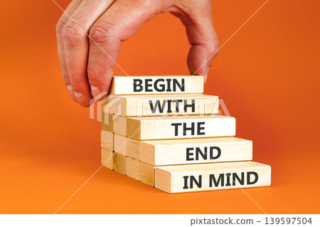 Begin with the end in mind symbol. Concept words Begin with the end in mind on beautiful wooden blocks. Beautiful orange paper background. Business begin with the end in mind concept. Copy space. Begin with the end in mind symbol. Concept words Begin with the end in mind on beautiful wooden blocks. Beautiful orange paper background. Business begin with the end in mind concept. Copy space. 139597504