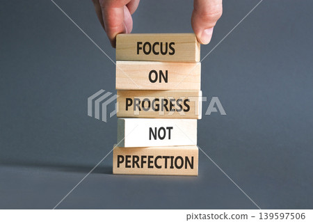 Progress or perfection words symbol. Concept words Focus on progress not perfection on beautiful wooden blocks. Beautiful grey paper background. Business progress or perfection concept. Copy space. Progress or perfection words symbol. Concept words Focus on progress not perfection on beautiful wooden blocks. Beautiful grey paper background. Business progress or perfection concept. Copy space. 139597506
