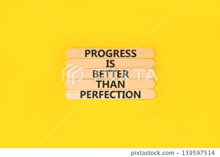Progress or perfection words symbol. Concept words Progress is better than perfection on beautiful wooden sticks. Beautiful yellow paper background. Business progress or perfection concept. Copy space Progress or perfection words symbol. Concept words Progress is better than perfection on beautiful wooden sticks. Beautiful yellow paper background. Business progress or perfection concept. Copy space 139597514