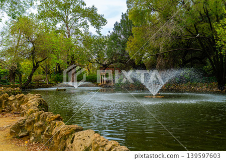 Fountain In Park Lake With Trees And Pavilion In Seville 139597603