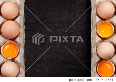 eggs in a tray on a dark background with copy space for your text. Top view eggs in a tray on a dark background with copy space for your text. Top view 139597631
