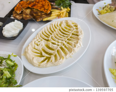Delicious Hummus Platter with Olive Oil Drizzle and Fresh Ingredients Delicious Hummus Platter with Olive Oil Drizzle and Fresh Ingredients 139597705