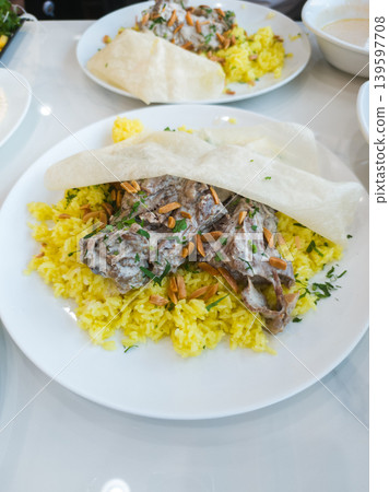 Jordanian Mansaf with Lamb Served on Yellow Rice and Crispy Bread Jordanian Mansaf with Lamb Served on Yellow Rice and Crispy Bread 139597708