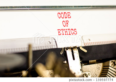 Code of ethics words symbol. Concept words Code of ethics typed on beautiful old retro typewriter. Beautiful white background. Business Code of ethics concept. Copy space. Code of ethics words symbol. Concept words Code of ethics typed on beautiful old retro typewriter. Beautiful white background. Business Code of ethics concept. Copy space. 139597774