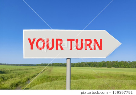 Your turn words symbol. Concept words Your turn on beautiful grey road sign. Beautiful blue sky green field background. Business your turn motivational support concept. Copy space. 139597791