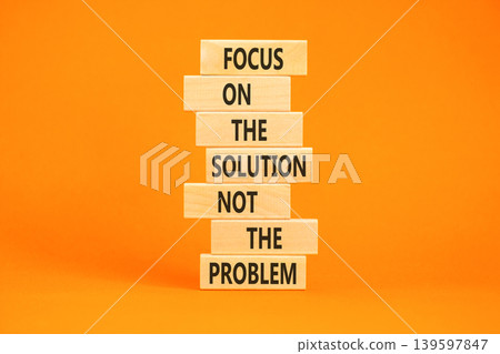 Problem and solution symbol. Concept words Focus on the solution not the problem on beautiful wooden blocks. Beautiful orange paper background. Business problem and solution concept. Copy space. 139597847