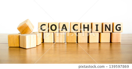 Coaching word symbol. Concept word Coaching on beautiful wooden blocks. Beautiful wooden table white background. Business support help coaching word concept. Copy space. Coaching word symbol. Concept word Coaching on beautiful wooden blocks. Beautiful wooden table white background. Business support help coaching word concept. Copy space. 139597869