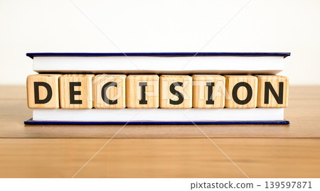 Decision word symbol. Concept word Decision on beautiful wooden blocks in beautiful book. Beautiful wooden table white background. Business support help decision word concept. Copy space. Decision word symbol. Concept word Decision on beautiful wooden blocks in beautiful book. Beautiful wooden table white background. Business support help decision word concept. Copy space. 139597871