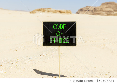 Code of ethics words symbol. Concept words Code of ethics on beautiful blackboard. Beautiful Sinai desert sand background. Business Code of ethics concept. Copy space. Code of ethics words symbol. Concept words Code of ethics on beautiful blackboard. Beautiful Sinai desert sand background. Business Code of ethics concept. Copy space. 139597884