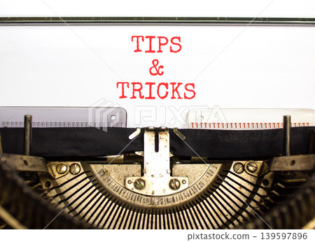 Tips and tricks words symbol. Concept words Tips and tricks typed on beautiful old retro typewriter. Beautiful white background. Business tips and tricks motivational support concept. Copy space. Tips and tricks words symbol. Concept words Tips and tricks typed on beautiful old retro typewriter. Beautiful white background. Business tips and tricks motivational support concept. Copy space. 139597896