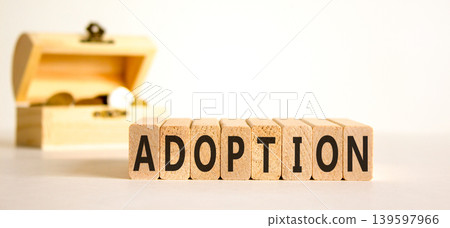 Adoption word symbol. Concept word Adoption on beautiful wooden blocks. Beautiful white background. Beautiful chest with coins. Business psychological support help adoption word concept. Copy space. Adoption word symbol. Concept word Adoption on beautiful wooden blocks. Beautiful white background. Beautiful chest with coins. Business psychological support help adoption word concept. Copy space. 139597966
