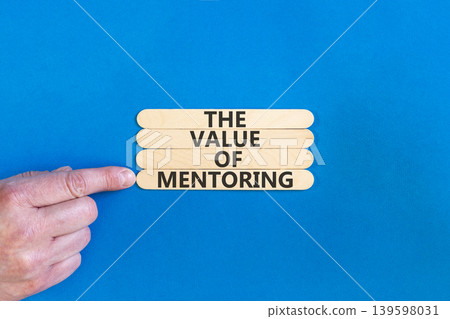 The value of mentoring words symbol. Concept words The value of mentoring on beautiful wooden sticks. Beautiful blue background. Businessman hand. Business the value of mentoring concept. Copy space The value of mentoring words symbol. Concept words The value of mentoring on beautiful wooden sticks. Beautiful blue background. Businessman hand. Business the value of mentoring concept. Copy space 139598031