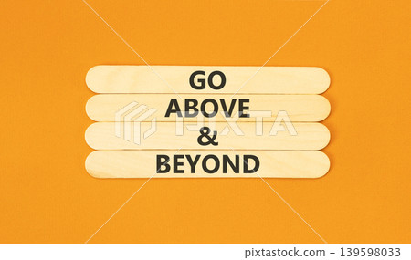 Go above and beyond words symbol. Concept words Go above and beyond on beautiful wooden sticks. Beautiful orange background. Business motivational Go above and beyond concept. Copy space. Go above and beyond words symbol. Concept words Go above and beyond on beautiful wooden sticks. Beautiful orange background. Business motivational Go above and beyond concept. Copy space. 139598033