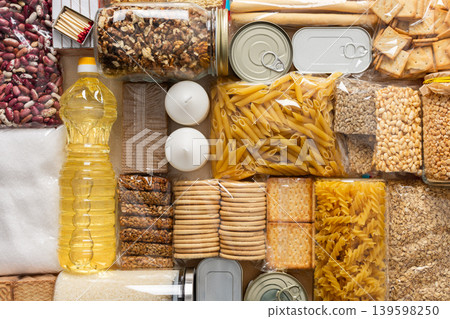 Home food supplies for quarantine and isolation, including canned food, cereals, pasta, and essential staples for survival, survival during military operations, the concept of stay at home 139598250
