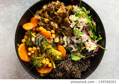 A filling, balanced breakfast with black quinoa, avocado, roast chicken, sweet potatoes, zucchini, broccoli, and a refreshing cabbage and radish salad with chia and sesame seeds 139598261