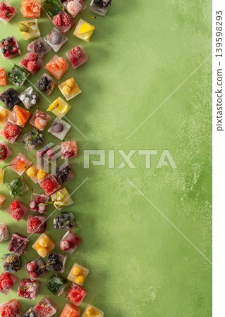 Ice cubes with frozen berries and fruits and mint on a green background Ice cubes with frozen berries and fruits and mint on a green background 139598293