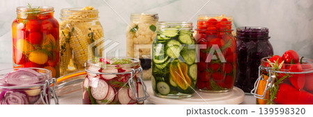 Fresh vegetables like cabbage, tomatoes, cucumbers and radishes, onions, corn, peppers and cauliflower, fermenting naturally to boost health and preserve nutrients, banner Fresh vegetables like cabbage, tomatoes, cucumbers and radishes, onions, corn, peppers and cauliflower, fermenting naturally to boost health and preserve nutrients, banner 139598320
