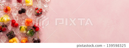 Pink background with ice cubes with frozen berries and fruits and mint, banner Pink background with ice cubes with frozen berries and fruits and mint, banner 139598325