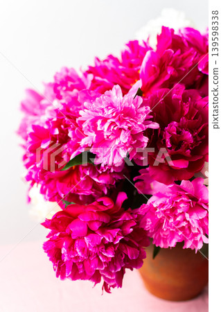 A vibrant arrangement of pink and white peonies showcases their lush petals. This floral display brings energy and beauty to any celebration or home decor setting A vibrant arrangement of pink and white peonies showcases their lush petals. This floral display brings energy and beauty to any celebration or home decor setting 139598338