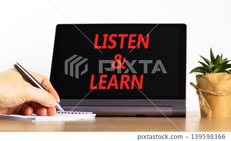 Listen and learn words symbol. Concept words Listen and learn on beautiful black tablet. Beautiful white background. Businessman hand. Business listen and learn support concept. Copy space. Listen and learn words symbol. Concept words Listen and learn on beautiful black tablet. Beautiful white background. Businessman hand. Business listen and learn support concept. Copy space. 139598366