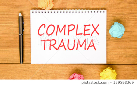Complex trauma words symbol. Concept words Complex trauma on beautiful white note. Beautiful wooden background. Black pen. Colored paper. Psychological complex trauma support concept. Copy space. Complex trauma words symbol. Concept words Complex trauma on beautiful white note. Beautiful wooden background. Black pen. Colored paper. Psychological complex trauma support concept. Copy space. 139598369