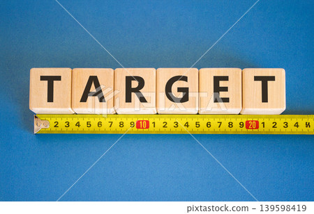 Target word symbol. Concept word Target on beautiful wooden blocks. Beautiful blue background. Beautiful yellow tape measure ruler. Business target word concept. Copy space. 139598419