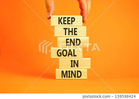 Keep the end goal in mind symbol. Concept words Keep the end goal in mind on beautiful wooden sticks. Beautiful orange paper background. Business keep the end goal in mind concept. Copy space. Keep the end goal in mind symbol. Concept words Keep the end goal in mind on beautiful wooden sticks. Beautiful orange paper background. Business keep the end goal in mind concept. Copy space. 139598424