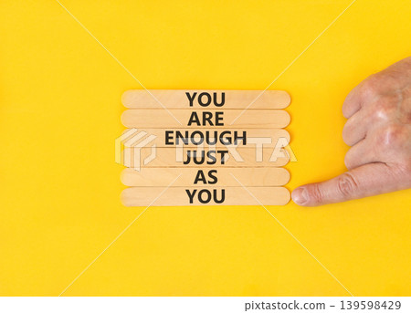 You are enough symbol. Concept words You are enough just as you on beautiful wooden sticks. Beautiful yellow background. Business motivational and you are enough just as you concept. Copy space. You are enough symbol. Concept words You are enough just as you on beautiful wooden sticks. Beautiful yellow background. Business motivational and you are enough just as you concept. Copy space. 139598429