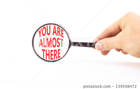 You are almost there words symbol. Concept words You are almost there on beautiful magnifying glass. Beautiful white background. Business You are almost there motivational support concept. Copy space. 139598472
