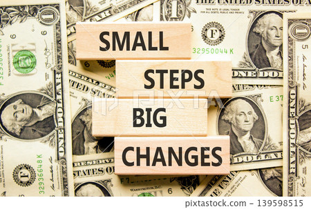 Small steps big changes symbol. Concept words Small steps big changes on beautiful wooden blocks. Beautiful dollar bills background. Business motivational small steps big changes concept. Copy space. Small steps big changes symbol. Concept words Small steps big changes on beautiful wooden blocks. Beautiful dollar bills background. Business motivational small steps big changes concept. Copy space. 139598515