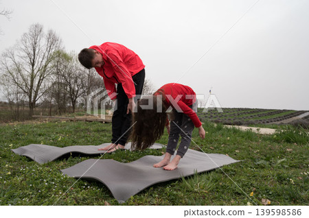Engaging with the natural world through intentional and mindful movements while surrounded by the serene beauty of the countryside on a tranquil, overcast afternoon 139598586