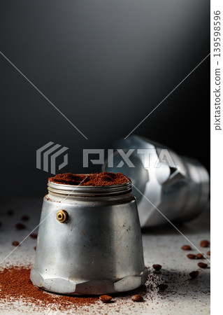 Coffee preparation in a classic Italian aluminium moka pot. Coffee preparation in a classic Italian aluminium moka pot. 139598596