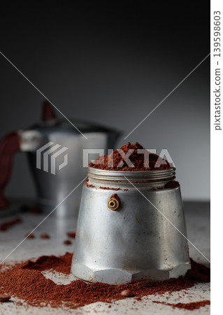 Coffee preparation in a classic Italian aluminium moka pot. Coffee preparation in a classic Italian aluminium moka pot. 139598603